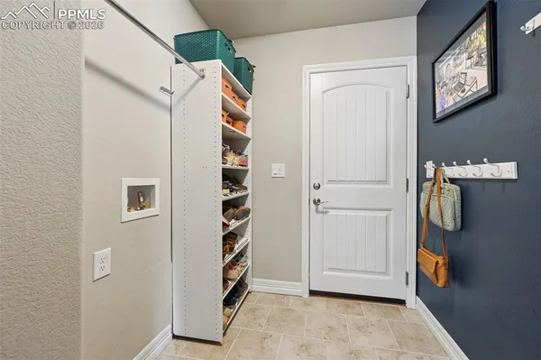 a spacious bedroom with a bed and a flat screen tv