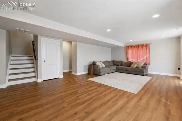a living room with furniture window and wooden floor
