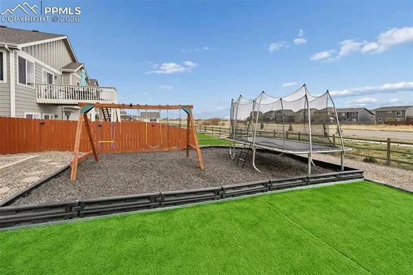 a backyard of a house with table and chairs