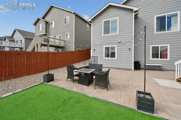 a view of a house with a yard and table