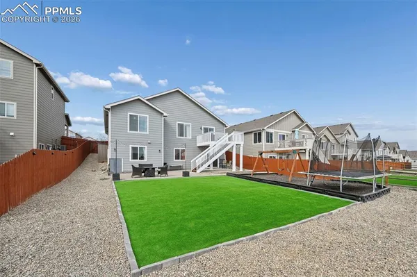 a view of a house with a yard and sitting area