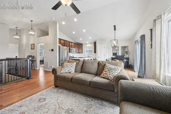 a living room with furniture and a chandelier