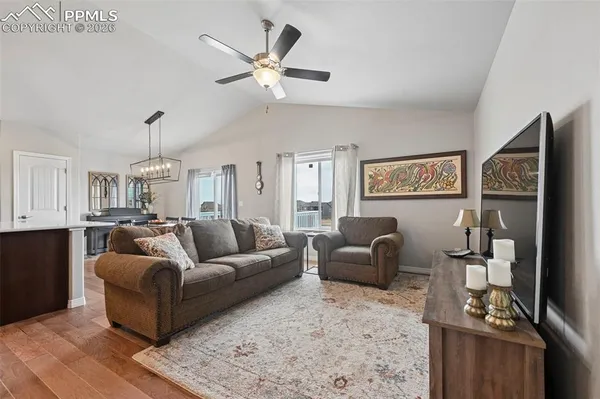 a living room with furniture and a chandelier
