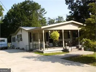 a view of a house with outdoor space and sitting area