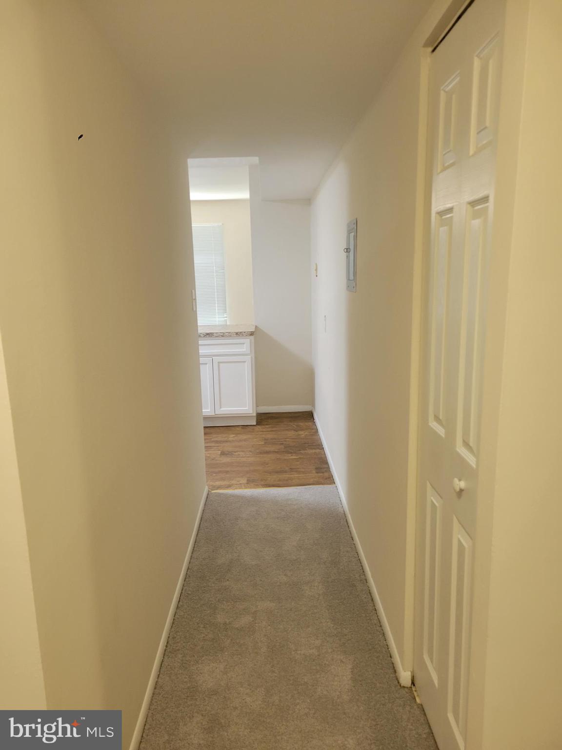 8431 Greenbelt Road Greenbelt, MD 20770 - Photo 10 of 16 a view of a hallway with wooden floor and a bathroom