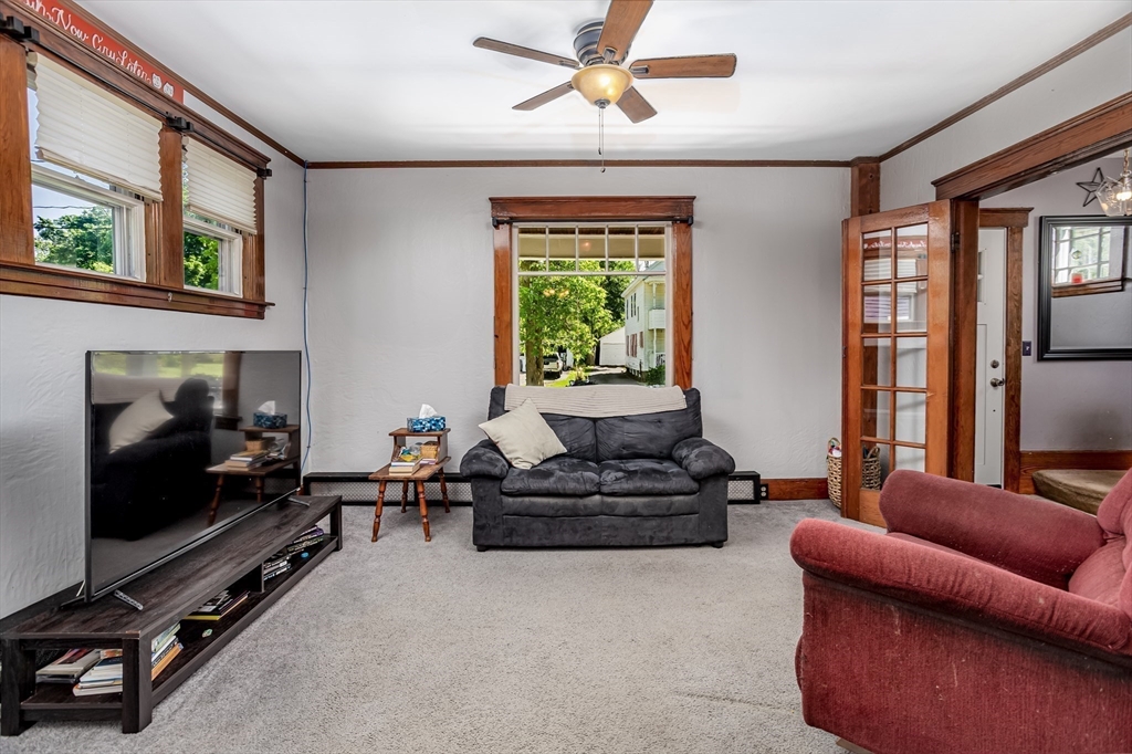 56 Orange Street Athol, MA 01331 - Photo 15 of 39 a living room with furniture a window and a flat screen tv