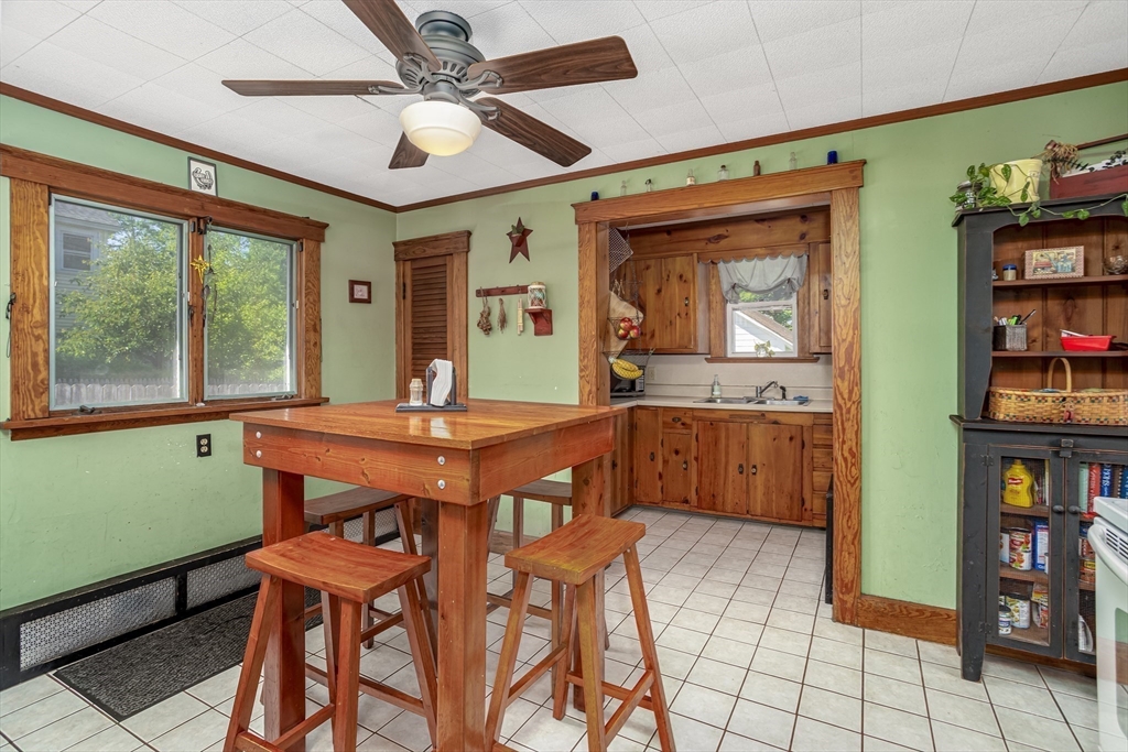 56 Orange Street Athol, MA 01331 - Photo 8 of 39 a dining room with stainless steel appliances a table and chairs in it