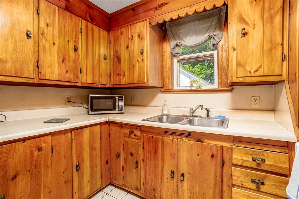 56 Orange Street Athol, MA 01331 - Photo 10 of 39 a kitchen with stainless steel appliances granite countertop a sink window and cabinets