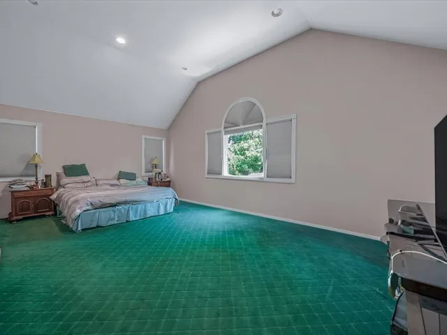 a spacious bathroom with a tub a window and a shower