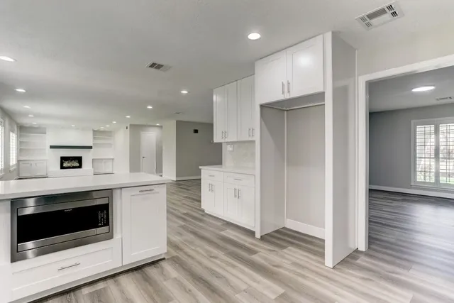 a kitchen with stainless steel appliances a white stove top oven and cabinets