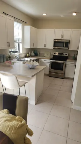 a kitchen with stainless steel appliances kitchen island granite countertop a sink and cabinets