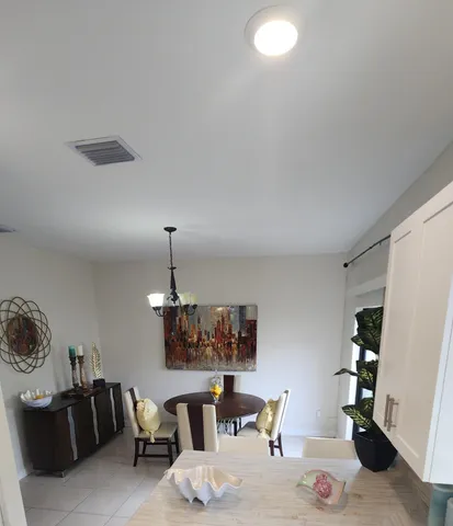 a living room with furniture a dining table and chairs with wooden floor