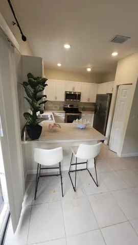 a view of kitchen with furniture and a potted plant