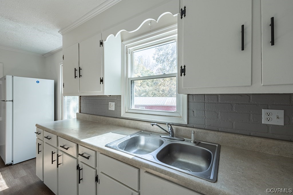 1122 Countyline Road Keysville, VA 23947 - Photo 7 of 20 a close view of a sink a faucet and a refrigerator in a kitchen