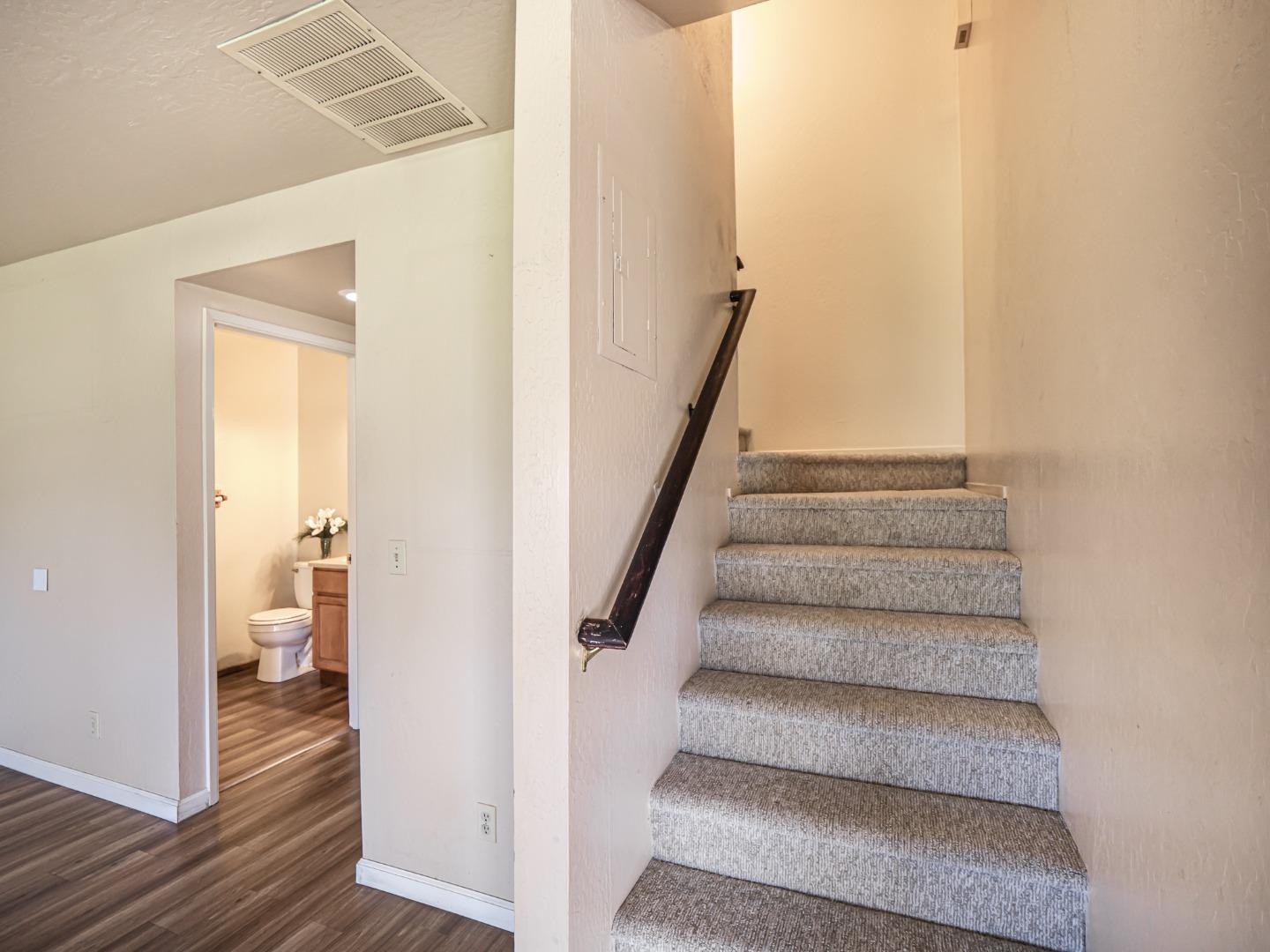216 Silver Leaf Drive, Unit C Watsonville, CA 95076 - Photo 15 of 36 a view of a hallway with wooden floor and staircase