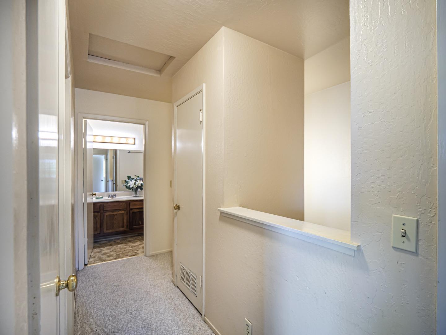 216 Silver Leaf Drive, Unit C Watsonville, CA 95076 - Photo 24 of 36 a view of a hallway with wooden floor and a bathroom