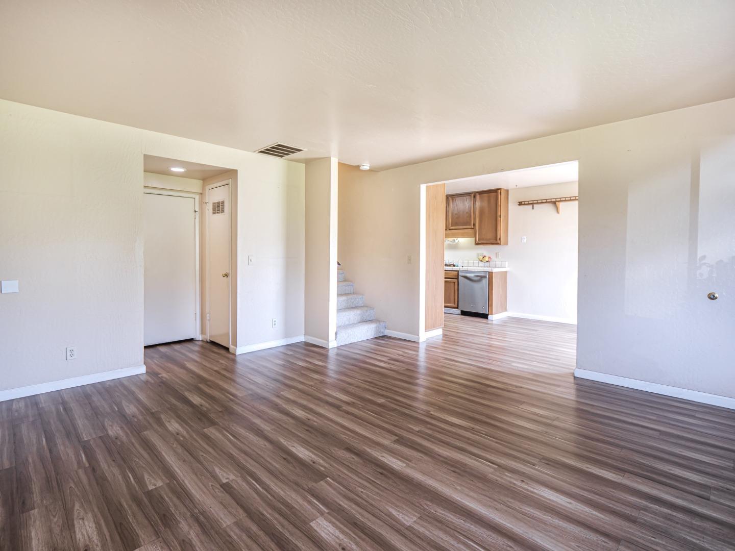 216 Silver Leaf Drive, Unit C Watsonville, CA 95076 - Photo 9 of 36 a view of an empty room with wooden floor and a window