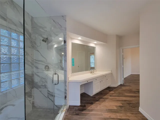 a bathroom with a double vanity sink and a mirror