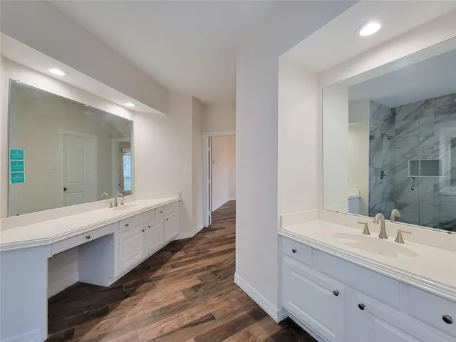 a bathroom with double vanity sinks and a large mirror