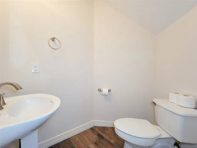 a white toilet sitting next to a white sink