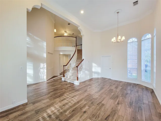 a view of a room with stairs and wooden floor