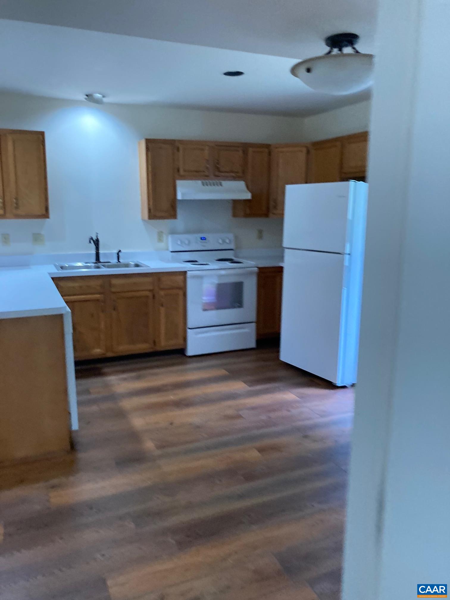 4773 Mechums River Road Charlottesville, VA 22901 - Photo 6 of 9 a kitchen with stainless steel appliances a large counter top a stove and a refrigerator