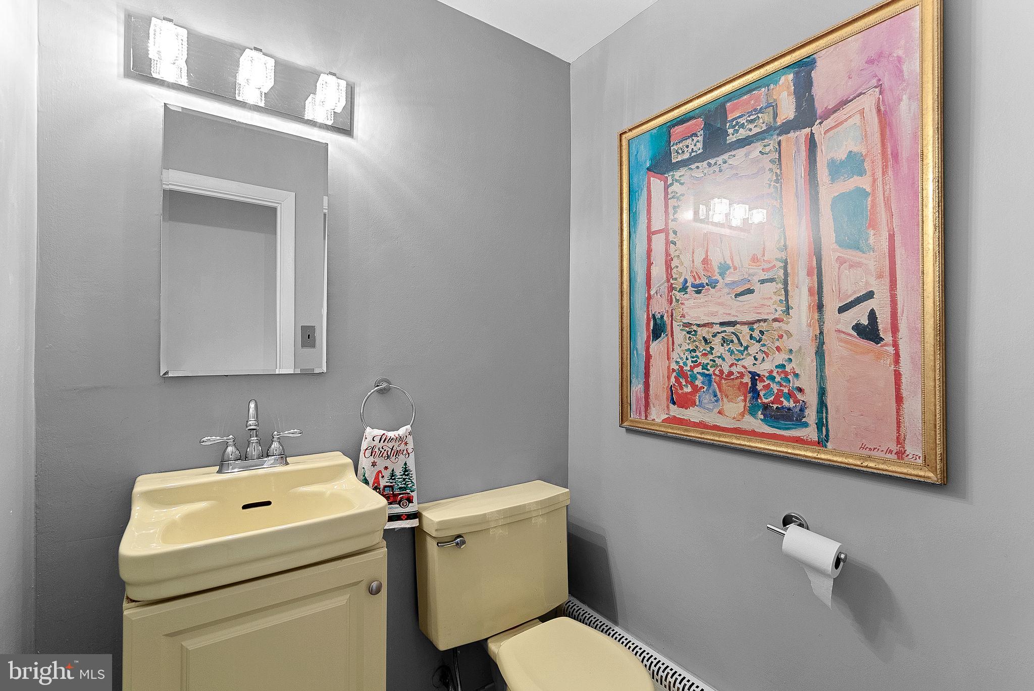 10021 Glenmere Road Fairfax, VA 22032 - Photo 16 of 45 a bathroom with a toilet a sink and mirror