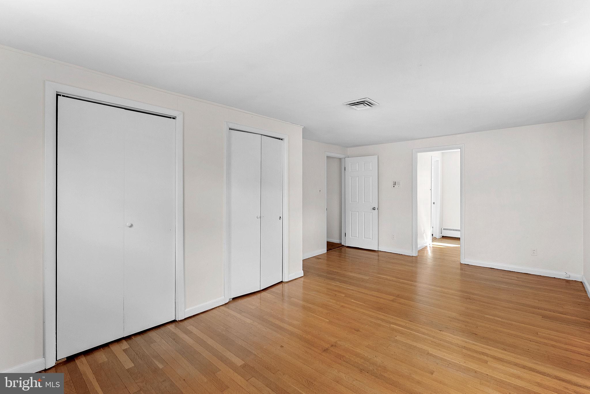 10021 Glenmere Road Fairfax, VA 22032 - Photo 18 of 45 a view of an empty room with wooden floor and a window