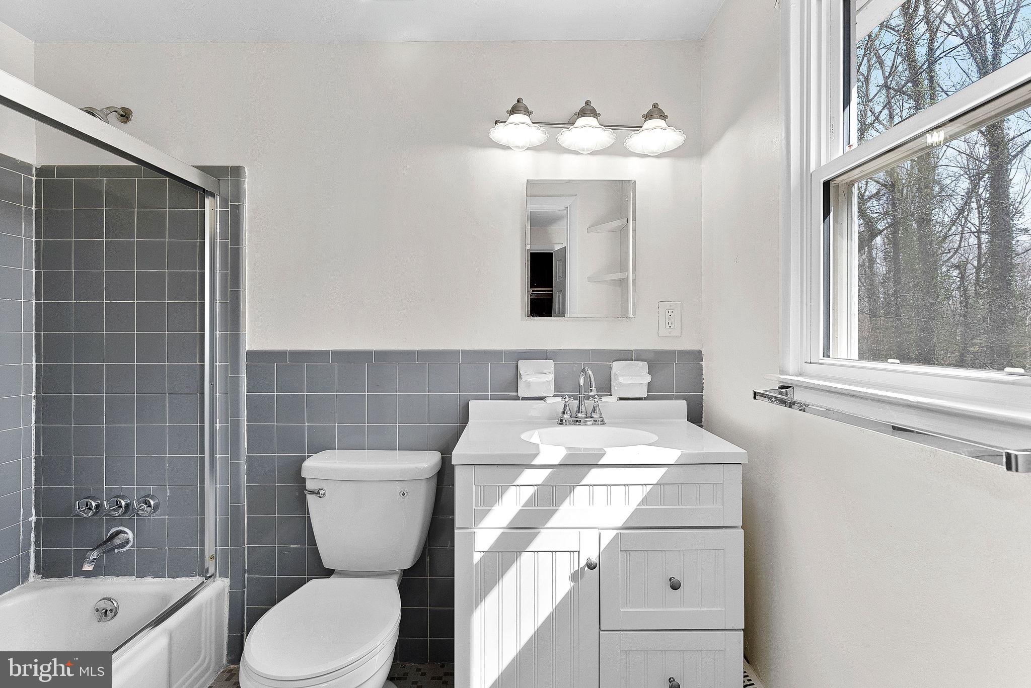 10021 Glenmere Road Fairfax, VA 22032 - Photo 21 of 45 a bathroom with a toilet sink and mirror
