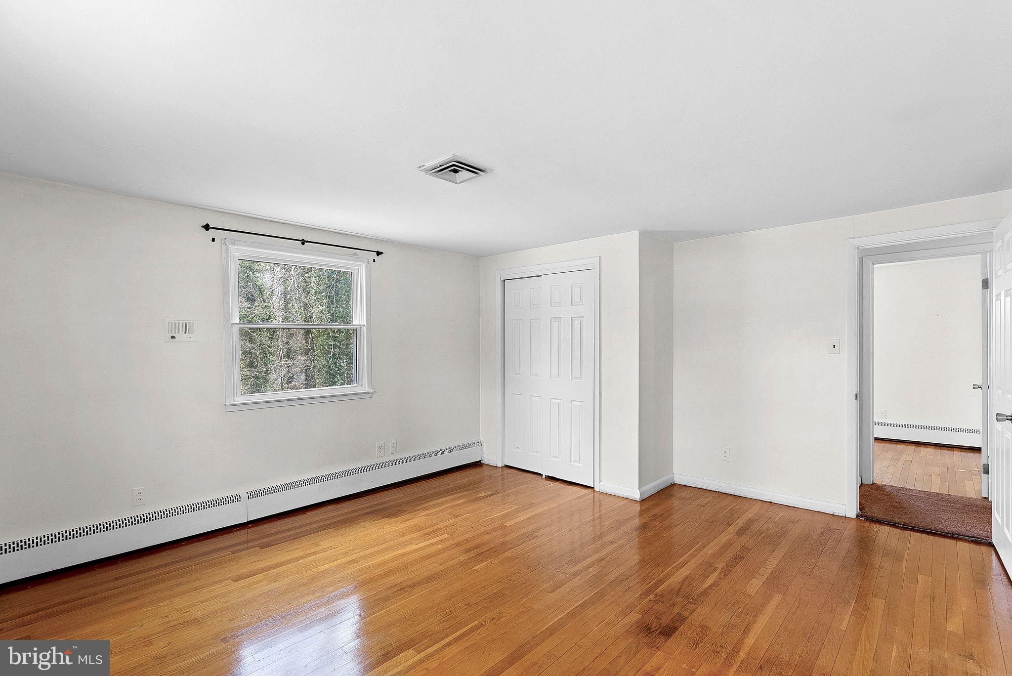 10021 Glenmere Road Fairfax, VA 22032 - Photo 25 of 45 a view of empty room with wooden floor and fan