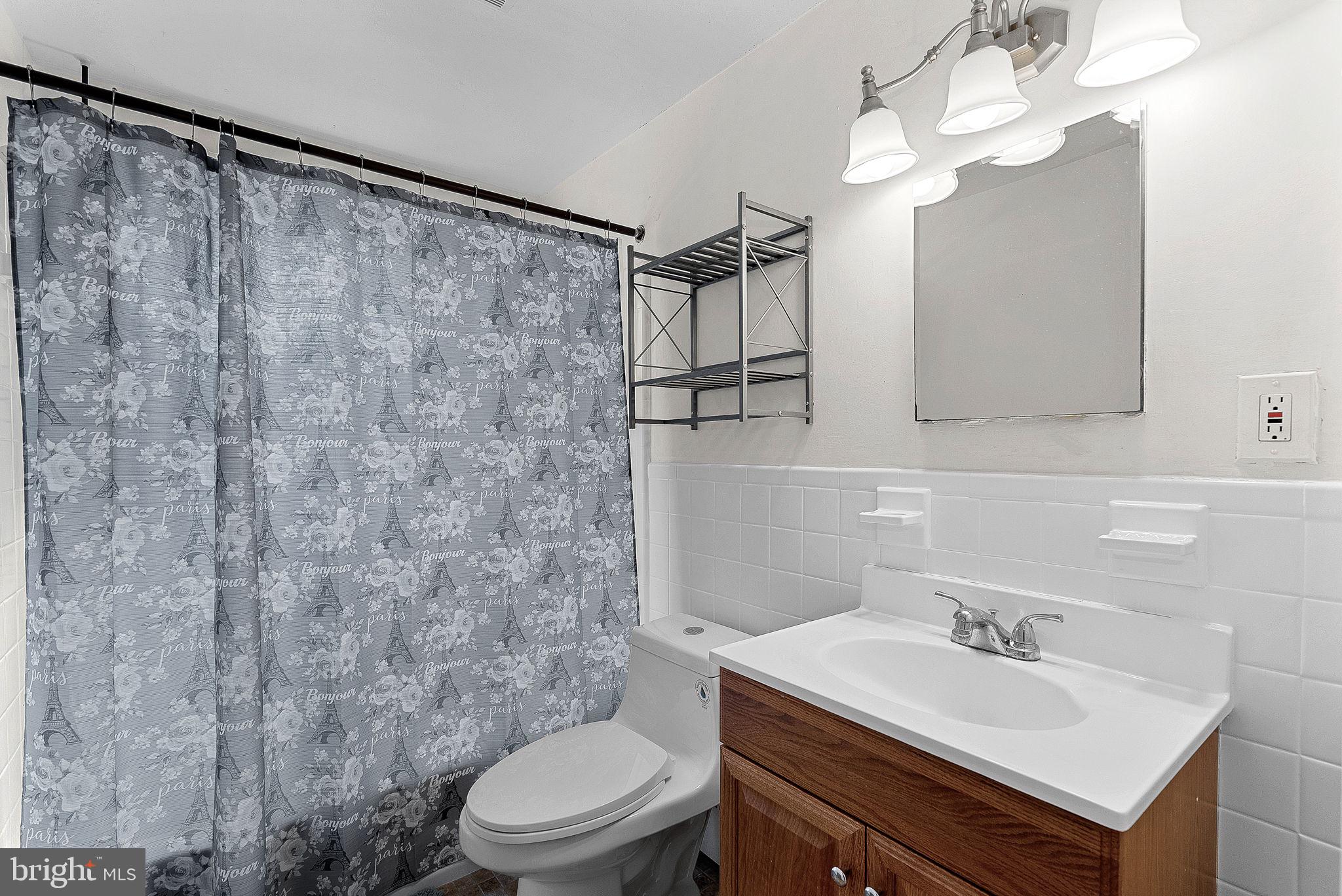 10021 Glenmere Road Fairfax, VA 22032 - Photo 27 of 45 a bathroom with a sink vanity mirror and toilet