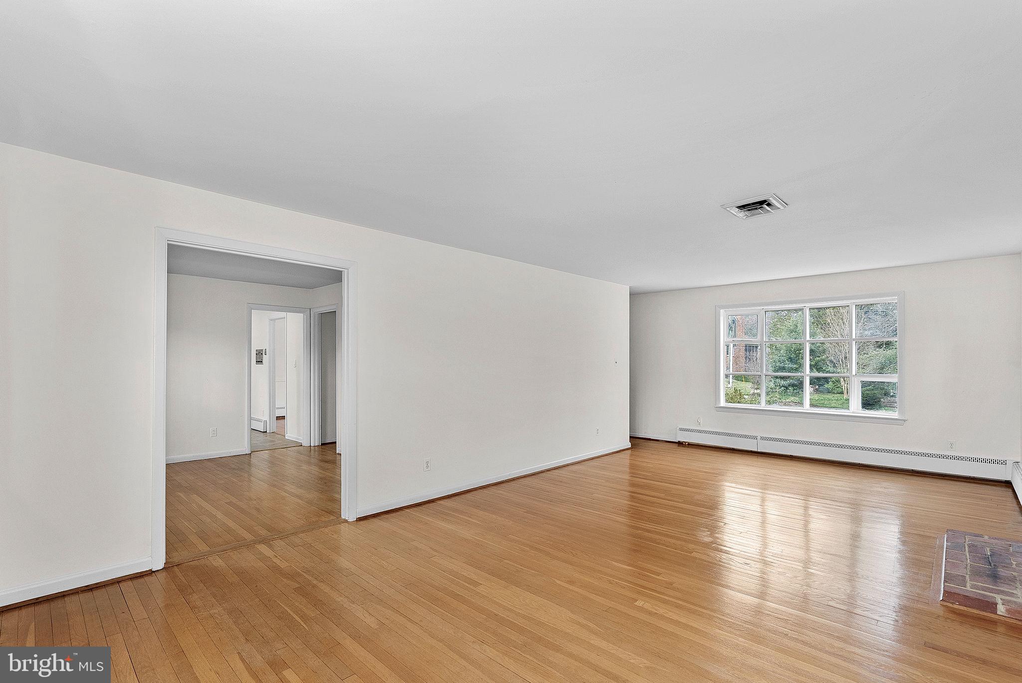 10021 Glenmere Road Fairfax, VA 22032 - Photo 7 of 45 a view of an empty room with wooden floor and a window