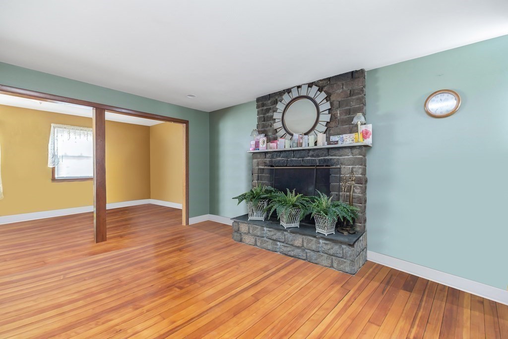 591 Grattan Street Chicopee, MA 01020 - Photo 12 of 36 a view of empty room with wooden floor and fan