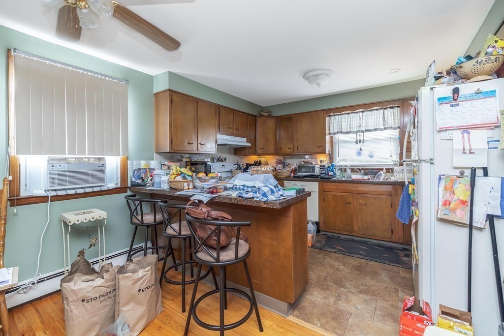 591 Grattan Street Chicopee, MA 01020 - Photo 14 of 36 a kitchen with stainless steel appliances granite countertop a stove a sink dishwasher and a refrigerator with wooden cabinets