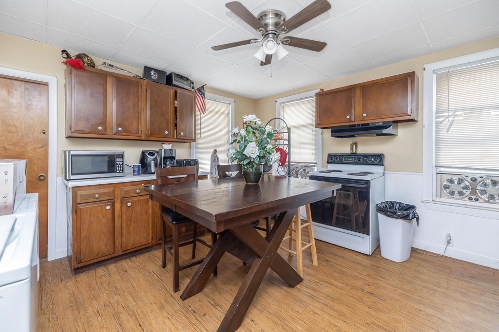 591 Grattan Street Chicopee, MA 01020 - Photo 17 of 36 a kitchen with a table chairs sink and cabinets