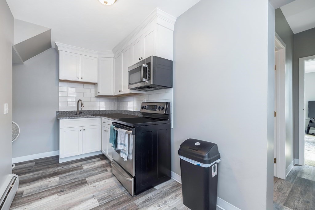 591 Grattan Street Chicopee, MA 01020 - Photo 5 of 36 a kitchen with stainless steel appliances granite countertop a stove and a refrigerator