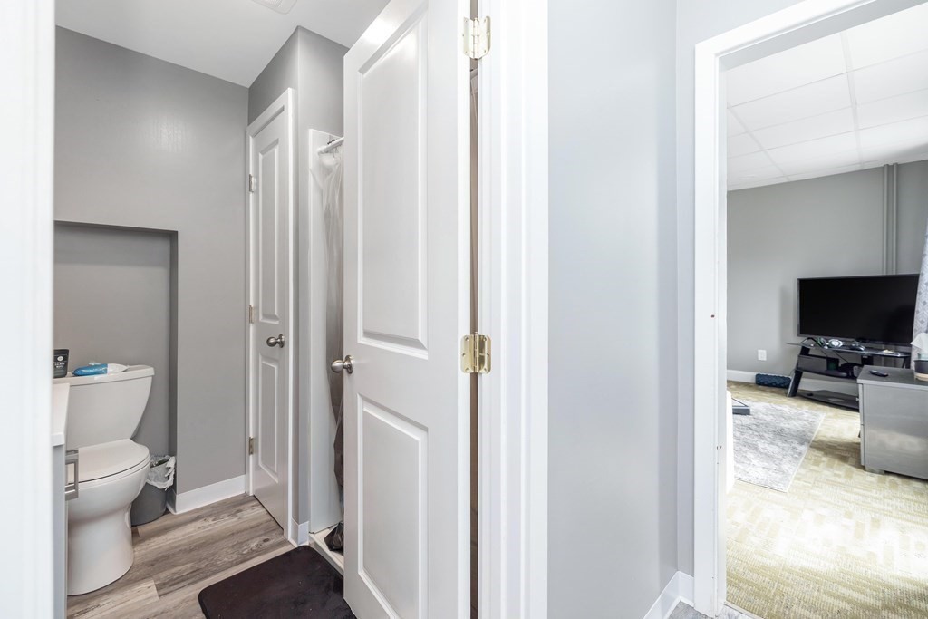 591 Grattan Street Chicopee, MA 01020 - Photo 7 of 36 a view of a bathroom with a toilet sink and a mirror
