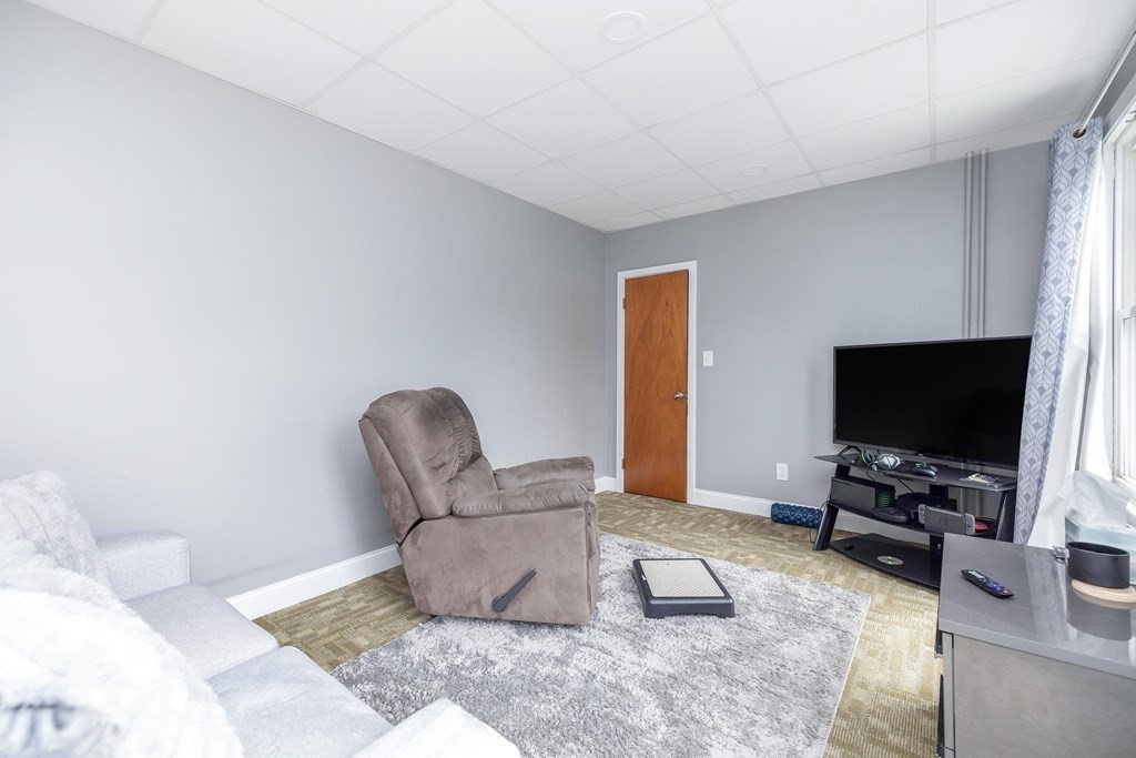 591 Grattan Street Chicopee, MA 01020 - Photo 8 of 36 a living room with furniture and a flat screen tv