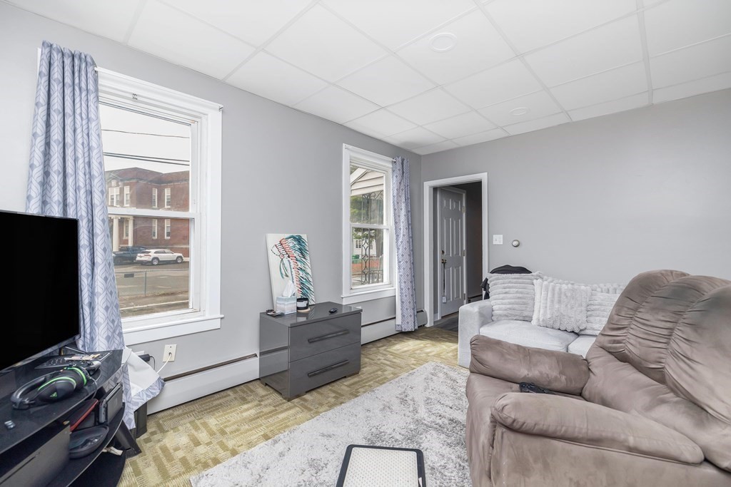 591 Grattan Street Chicopee, MA 01020 - Photo 9 of 36 a living room with furniture and a flat screen tv