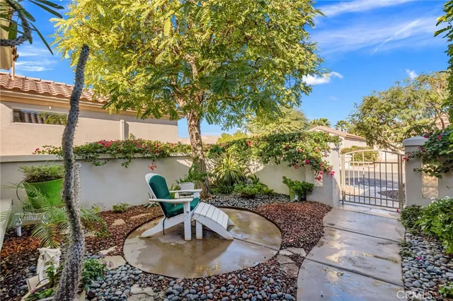 a living room with patio furniture and a floor to ceiling window
