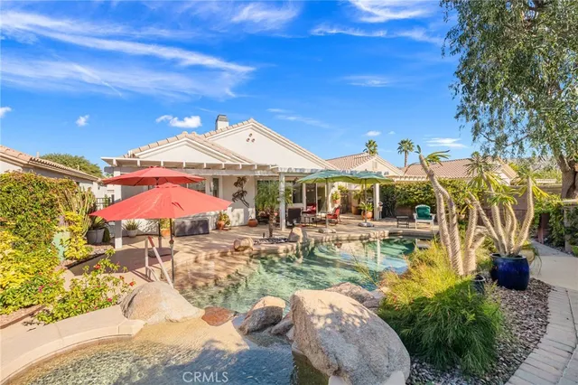a view of a patio with swimming pool table and chairs