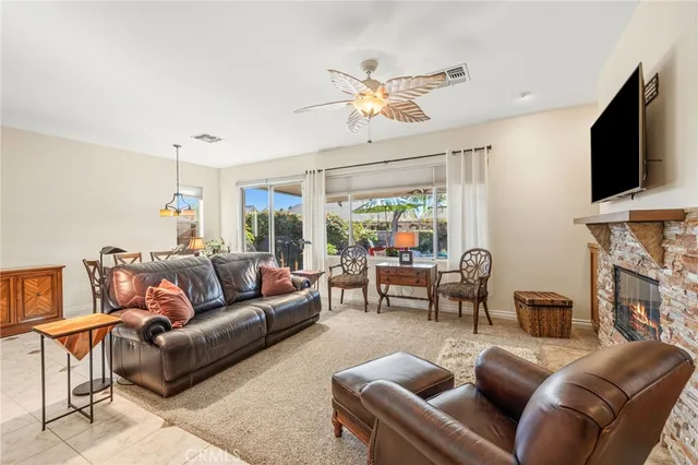 a living room with furniture a flat screen tv and a window