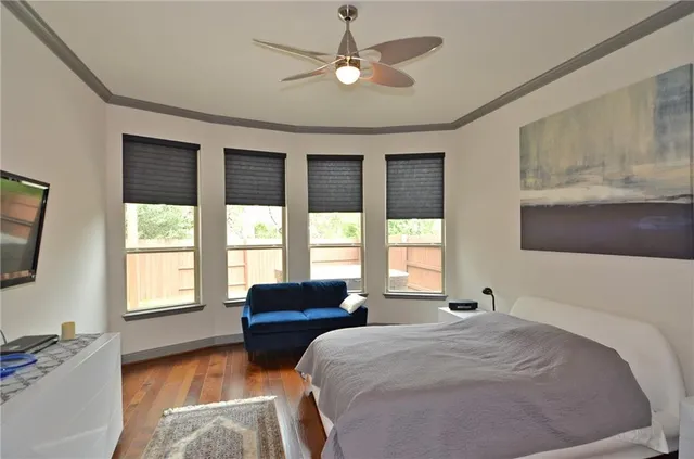 a spacious bedroom with a large bed and a chandelier
