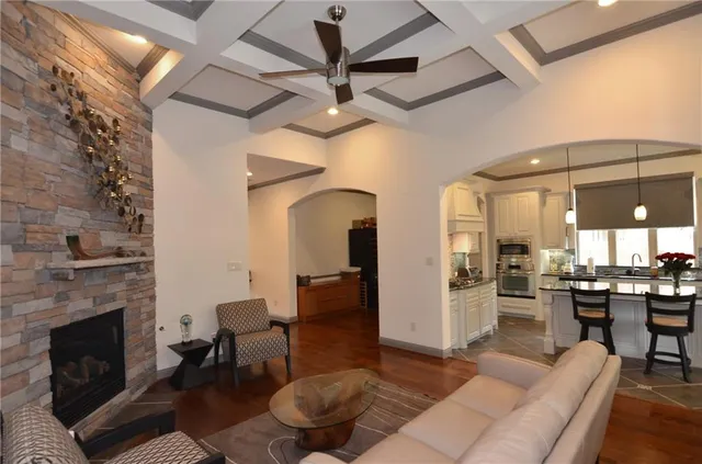 a living room with furniture a fireplace and a table