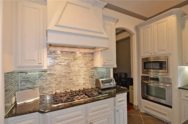 a kitchen with stainless steel appliances a stove and a refrigerator