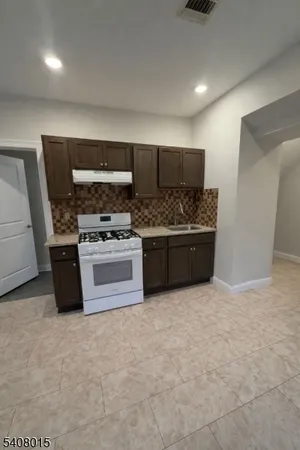 a kitchen with stainless steel appliances a stove and a refrigerator
