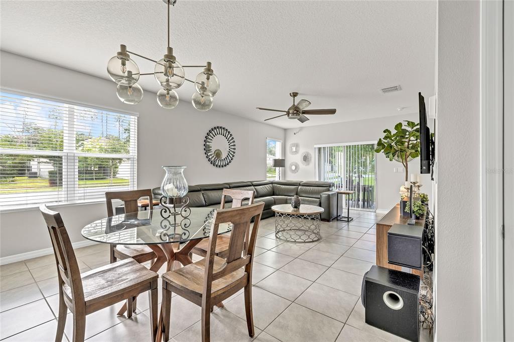 115 Duchess Road DeLand, FL 32724 - Photo 11 of 37 a view of a dining room and livingroom furniture wooden floor a chandelier