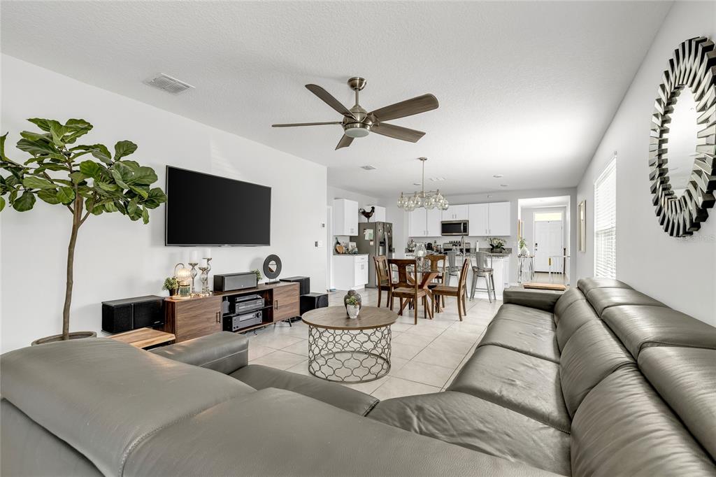 115 Duchess Road DeLand, FL 32724 - Photo 13 of 37 a living room with furniture and a flat screen tv