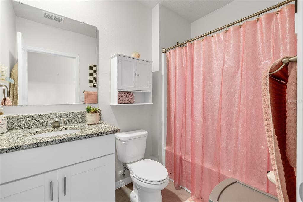 115 Duchess Road DeLand, FL 32724 - Photo 26 of 37 a bathroom with a granite countertop sink and a mirror