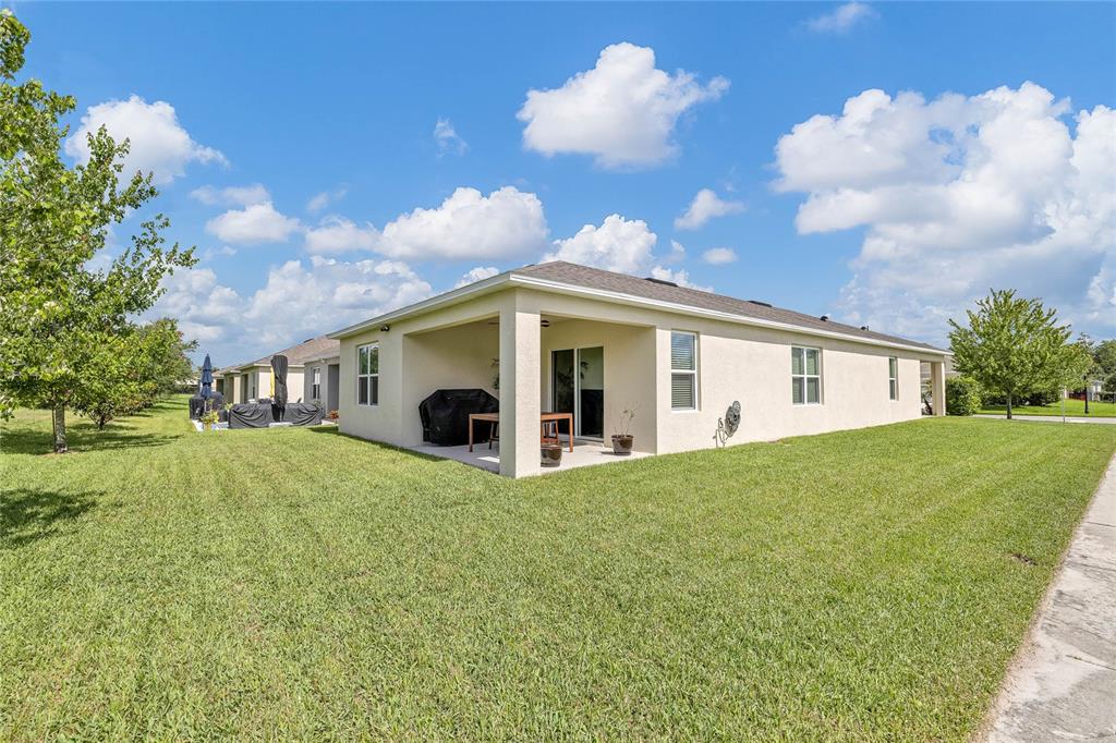 115 Duchess Road DeLand, FL 32724 - Photo 32 of 37 a front view of house with yard and trees in the background
